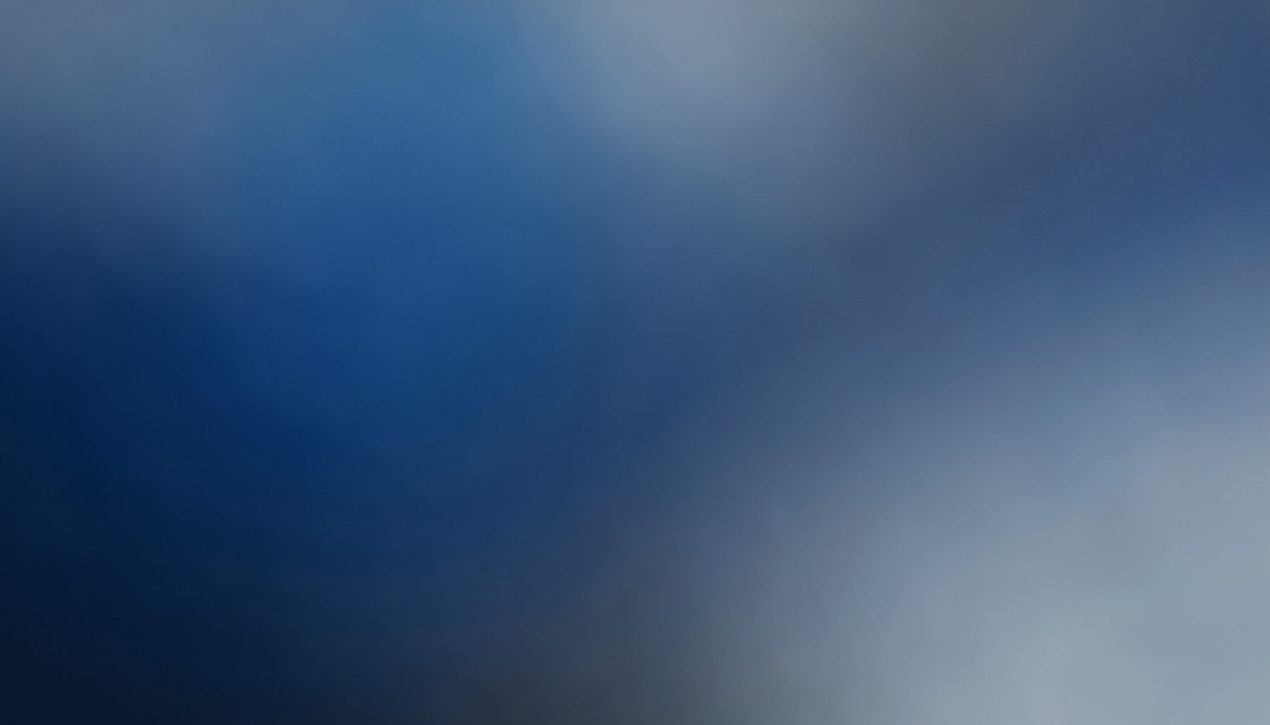 Abstract blurred gradient in deep slate blue and muted gray tones, soft and atmospheric